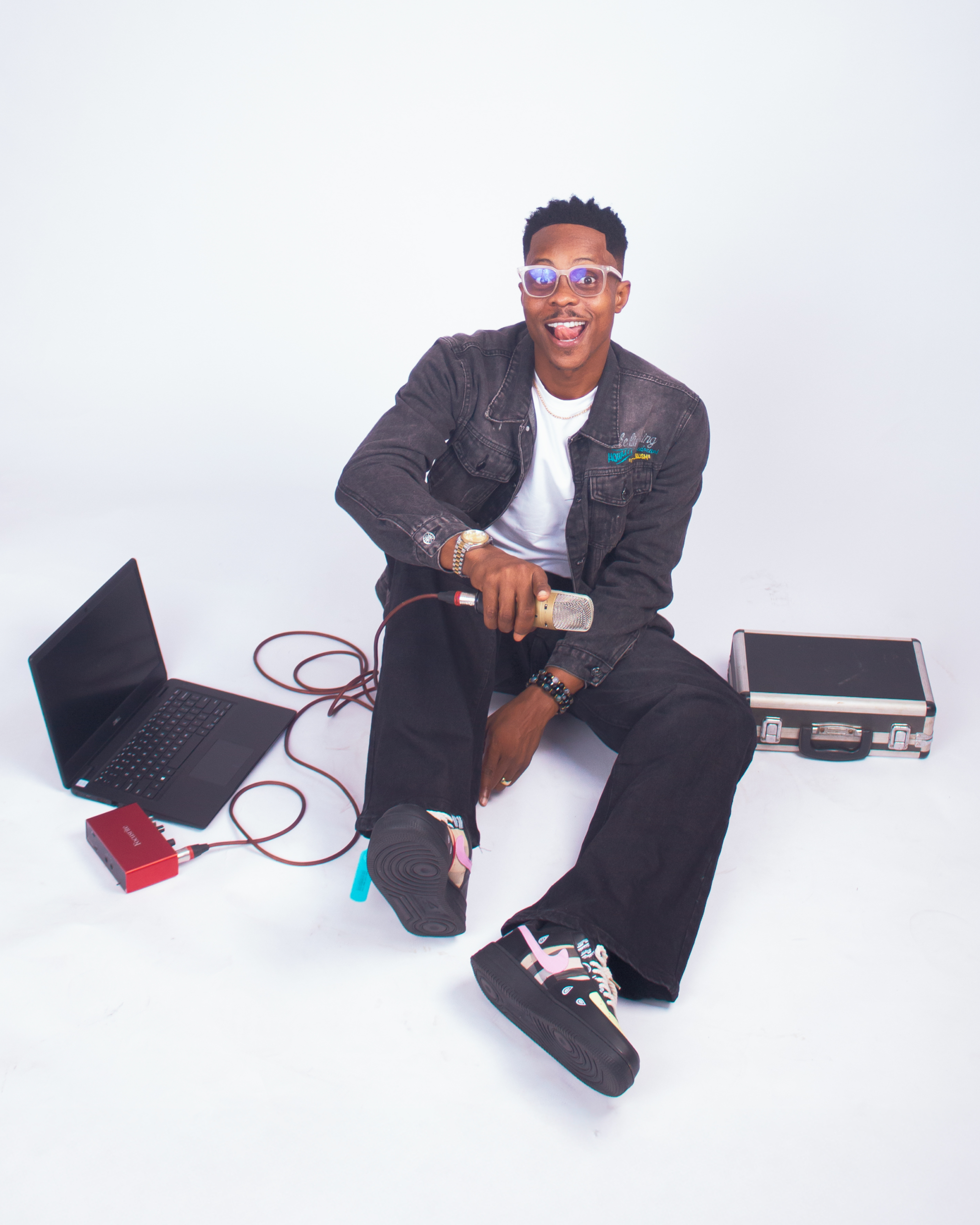 Honeytongue seated with his music production and DJ setup